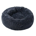 Dog relaxing in the ZenHound calming donut bed